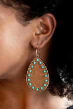 Load image into Gallery viewer, Dainty turquoise stone beads border an earthy wooden teardrop frame that is encased in a sleek silver fitting, creating a whimsical woodsy lure. Earring attaches to a standard fishhook fitting.  Sold as one pair of earrings.  New Kit Fashion Fix
