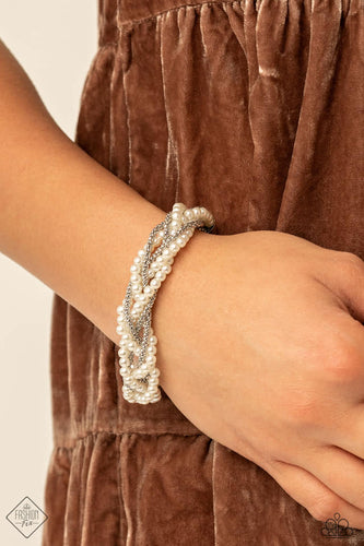 Capped in silver fittings, strands of bubbly white pearls and dainty silver popcorn chains delicately weave around the wrist, creating an elegantly effervescent display. Features an adjustable clasp closure.  Sold as one individual bracelet.