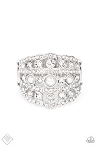 Layers of dainty silver bands, encrusted with sparkling white rhinestones, are accented with a trio of petite pearls on the centermost band. The stacked layers sweep across the finger, making an exquisite centerpiece. Features a stretchy band for a flexible fit.  Sold as one individual ring.  New Kit Fashion Fix