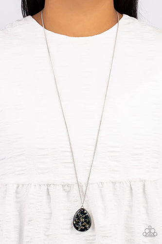 Featuring a shell-like iridescence, shimmery flecks are sprinkled along a shiny black backdrop inside of a glassy casing. The colorful teardrop swings from the bottom of an extended silver chain, creating a summery pendant. Features an adjustable clasp closure.  Sold as one individual necklace. Includes one pair of matching earrings.