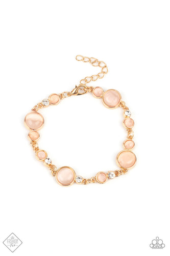 Encased in sleek gold fittings, a bubbly collection of champagne cat's eye stones and glassy white rhinestones coalesce into mismatched frames that delicately connect around the wrist for an effervescent elegance. Features an adjustable clasp closure.  Sold as one individual bracelet.  New Kit Fashion Fix