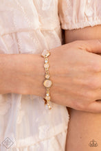 Load image into Gallery viewer, Encased in sleek gold fittings, a bubbly collection of champagne cat&#39;s eye stones and glassy white rhinestones coalesce into mismatched frames that delicately connect around the wrist for an effervescent elegance. Features an adjustable clasp closure.  Sold as one individual bracelet.  New Kit Fashion Fix
