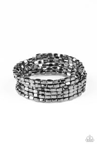 A glistening collection of rectangular gunmetal beads are threaded along a coiled wire, creating a shimmer infinity wrap style bracelet around the wrist.  Sold as one individual bracelet.