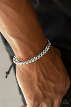 Load image into Gallery viewer, Shiny black cording knots around the ends of a thick silver curb chain that is wrapped across the top of the wrist for a versatile look. Features an adjustable sliding knot closure.  Sold as one individual bracelet.
