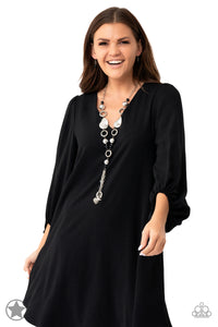 Long chain of black crystalized beads, curved plates of silver with a pearly finish, and chunky silver rings lead down to a tassel of chains and charms, including a crescent moon and a heart.     Sold as one individual necklace. Includes one pair of matching earrings.