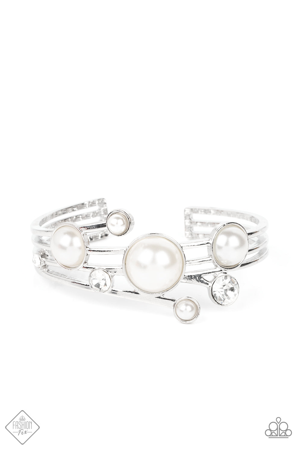 Luxuriously oversized pearl beads, encased in silver frames, mingle with brilliant white rhinestones, as they drift across silver bands that flare out on either side before wrapping into an airy cuff around the wrist.  Sold as one individual bracelet.  New Kit Fashion Fix