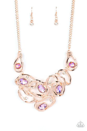 Warped rose gold frames asymmetrically curl around dainty white rhinestones and iridescent peach gem accents, interlocking into a contemporary statement piece below the collar. Features an adjustable clasp closure. Due to its prismatic palette, color may vary.  Sold as one individual necklace. Includes one pair of matching earrings.  Life of the Party Exclusive, July 2022