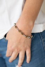 Load image into Gallery viewer, Featuring studded silver fittings, brown cat&#39;s eye stone frames delicately connect with ornate silver links around the wrist for an enchanted fashion. Features an adjustable clasp closure.  Sold as one individual bracelet.
