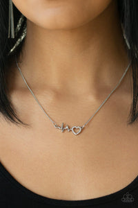 Reminiscent of a heartbeat, a wavy silver bar attaches to a charming heart silhouette for a simply beautiful display. Dazzling white rhinestones are sprinkled along the heart charm for a sparkling finish. Features an adjustable clasp closure.  Sold as one individual necklace. Include one pair of matching earrings.