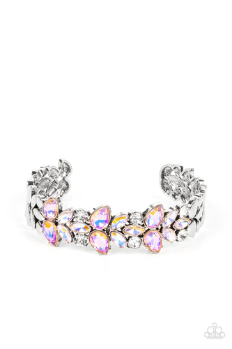 Iridescent coral teardrop and iridescent peach marquise gems converge with classic white rhinestones to create a subtle floral motif across the front of a silver cuff. The prismatic accents add an air of mystery to the piece, while smooth flattened silver discs border the gleaming gems in a high sheen finish. Due to its prismatic palette, color may vary.  Sold as one individual bracelet.