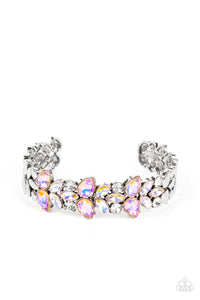 Iridescent coral teardrop and iridescent peach marquise gems converge with classic white rhinestones to create a subtle floral motif across the front of a silver cuff. The prismatic accents add an air of mystery to the piece, while smooth flattened silver discs border the gleaming gems in a high sheen finish. Due to its prismatic palette, color may vary.  Sold as one individual bracelet.