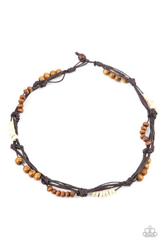 Featuring round and disc shapes, mismatched sections of brown and white wooden beads are knotted along strands of brown cording that loop around the neck for an island inspired look. Features a button loop closure.